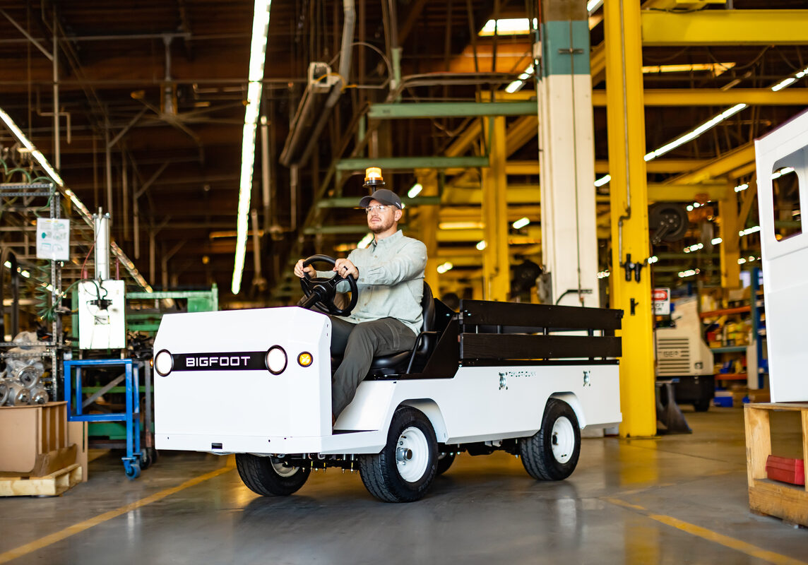 Taylor-Dunn-Bigfoot-S-with-operator-Manufacturing-Factory-Beauty-Edited-Selects-07-1200x800-5b2df79